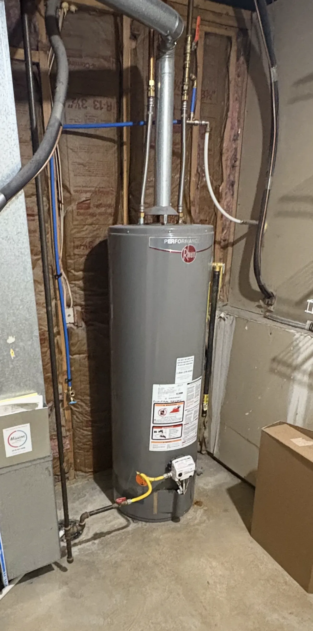 water heater, pipes, insulation, ductwork, concrete floor, cardboard box