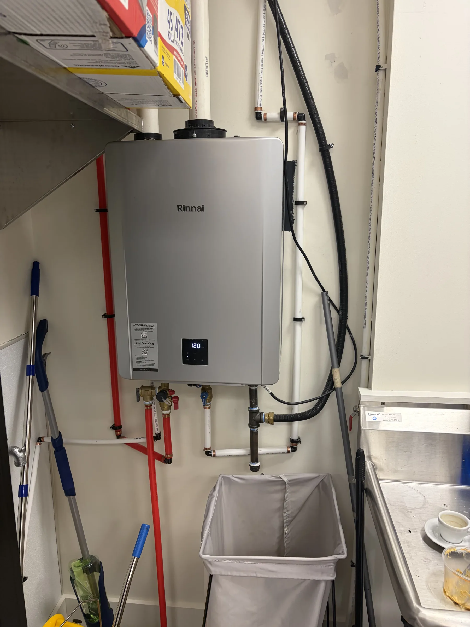 rinnai, water heater, mop, bucket, trash can, cup of coffee